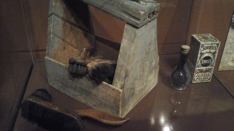 Penniless and homeless shoeshine boys were all over urban streets during the nineteenth century. The polishes they used for shining shoes frequently put their health at risk. Moreover, these boys were vulnerable to abuse from people taking advantage of their impoverished situation. A shoeshine boy’s kit consisted of brushes, rags, polish, and a box to dually function as a stand for customers. Polish contained nitrobenzene: despite smelling quite pleasant, it oxidized iron in blood when contacted to the skin, causing dizziness, nausea, cyanosis, and even death.  Shoeshine kit, American, c.19th century (Collection of the Bata Shoe Museum  