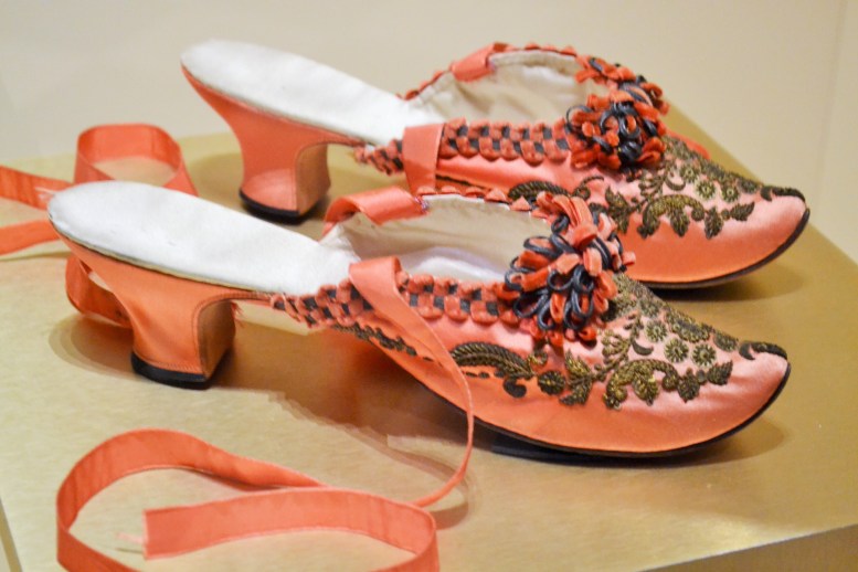 The high-heel was reintroduced in the mid-1850s after a period of banishment during the early nineteenth century. The “Louis heel” of these boudoir slippers, reflected eighteenth-century fashion trends, including the highly erotic image of femininity. It was believed that high-heels went a long way in framing women’s roles as consumers rather than producers.  Shoes: English, c.1880-1883 (Collection of the Bata Shoe Museum)  